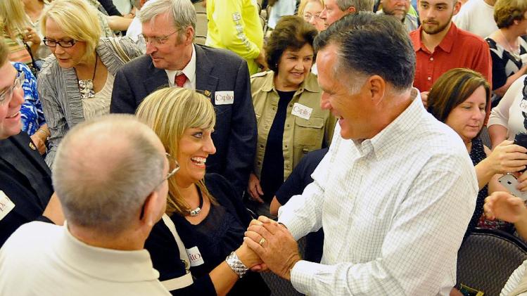 Former Massachusetts Gov. Mitt Romney shakes hands with supporter Mary Jo Pitzer at Tamarack during the Working for Jobs Rally in Beckley, W.Va., Tuesday, Aug. 19, 2014. (AP Photo/Chris Tilley)