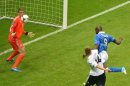 Italy forward Mario Balotelli (R) scores past Germany goalkeeper Manuel Neuer after 20 minutes