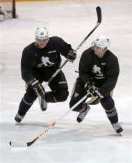 Pittsburgh Penguins' Sidney Crosby, left, skates up ice with teammate Chris Kunitz during a hockey workout on Thursday, Jan. 3, 2013, at the IceoPlex in Canonsburg, Pa. Crosby knows the NHL season, if and when it starts, will be a sprint. That should favor teams like the Penguins, who endured little turnover in the long offseason. (AP Photo/Keith Srakocic)