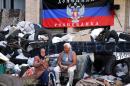 Elderly people sit in front a barricade set outside the city hall seized by pro-Russian separatists in the eastern Ukrainian city of Kramatorsk on June 6, 2014