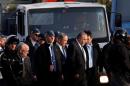 Israeli Prime Minister Benjamin Netanyahu (C) and Defense Minister Avigdor Lieberman visit the scene where police said a Palestinian rammed his truck into a group of Israeli soldiers on a popular promenade in Jerusalem