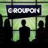 FILE - In this Sept. 22, 2011 file photo, employees at Groupon pose in silhouette with the company logo in the lobby of the online coupon company's Chicago offices. Daily deals company Groupon Inc.'s initial public offering is expected to price after the market closes Thursday, Nov. 3, 2011, with some analysts expecting the stock to price slightly above its current range of $16 to $18. (AP Photo/Charles Rex Arbogast, File)