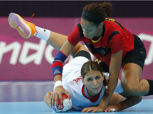 Croatia's Andrea Penezic falls to the ground after being pushed by Angola's Nair Almeida in their women's handball Preliminaries Group A match at the Copper Box venue during the London 2012 Olympic Ga