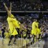 Michigan's Trey Burke, second from left, is lifted by Corey Person after beating Kansas  87-85 in overtime of a regional semifinal game in the NCAA college basketball tournament, Friday, March 29, 2013, in Arlington, Texas.(AP Photo/Tony Gutierrez)