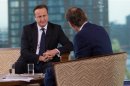 Britain's Prime Minister David Cameron listens as he appears on the BBC's Andrew Marr Show, on the first day of the of the Conservative Party annual conference in Manchester