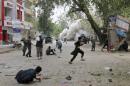 People run for cover after an explosion in Jalalabad