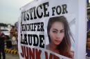 Protesters display a placard with a picture of Laude during a rally in Manila