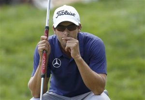Australia's Adam Scott looks at his putt on the third hole during the final round of the 2013 PGA Championship golf tournament at Oak Hill Country Club in Rochester