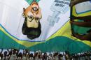 Demonstrators wave a flag with a draw of Brazil's President Dilma Rousseff during an anti-government demonstration in Copacabana in Rio de Janeiro