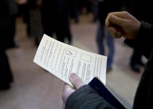 A man holds a ballot after casting a vote in favor&nbsp;&hellip;