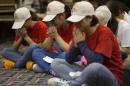 Relatives of Chinese passengers on board the Malaysia Airlines Flight 370 pray at a hotel conference room in Beijing, China, Friday, April 18, 2014. A robotic submarine headed back down into the depths of the Indian Ocean on Friday to scour the seafloor for any trace of the missing Malaysian jet one month after the search began off Australia's west coast, as data from the sub's previous missions turned up no evidence of the plane.(AP Photo/Ng Han Guan)