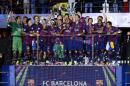 Barcelona players celebrate with the trophy after the Champions League final soccer match between Juventus Turin and FC Barcelona at the Olympic stadium in Berlin Saturday, June 6, 2015. Barcelona won the match 3-1. (AP Photo/Luca Bruno)