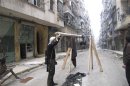 Free Syrian Army fighter holds improvised catapult in Aleppo's district of Salaheddine
