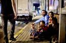 A Syrian refugee family sit on a street in Istanbul in this United Nations High Commissioner for Refugees photo from August 1, 2014