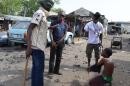 Vigilantes dubbed 'Civilian JTF' interrogate a suspected Boko Haram informant in the northeast Nigerian city of Maiduguri on May 24, 2014