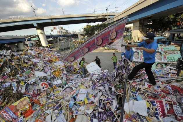 Philippine workers discared election banners and posters at a depot in Manila on May 11, 2010. The Philippines is set to regulate Internet advertising in May mid-term polls as part of an effort to rein in campaign spending, according to election officials