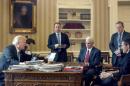 President Donald Trump, accompanied by, from second from left, Chief of Staff Reince Priebus, Vice President Mike Pence, White House press secretary Sean Spicer and National Security Adviser Michael Flynn, speaks on the phone with with Russian President Vladimir Putin, Saturday, Jan. 28, 2017, in the Oval Office at the White House in Washington. (AP Photo/Andrew Harnik)