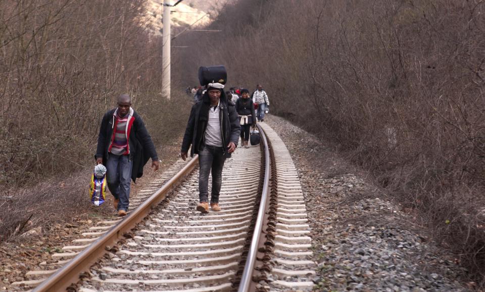 In this Saturday, Feb. 28, 2015 photo West African migrants walk on train tracks on their way towards the border with Macedonia near the town of...