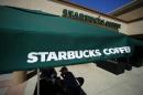Customers enjoy their drinks outside a newly designed Starbucks coffee shop in Fountain Valley