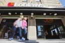 People walk by a Loblaw Companies Limited grocery store with a Joe Fresh clothing store inside, in Toronto