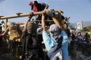 Anti-government protesters unload debris from a truck to build a barricade along a highway during a protest in Caracas