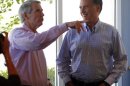 Republican presidential candidate and former Massachusetts Governor Mitt Romney and U.S. Senator Rob Portman (R-OH) wait in line to order food at a Chipotle Restaurant in Denver