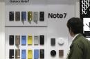 In this photo taken on Wednesday, Oct. 5, 2016, a visitor looks at the smartphone cases of Samsung Electronics's Galaxy Note 7 at a shop in Seoul, South Korea. Samsung Electronics Co. estimated its profit rose more than expected in the July-September quarter despite the unprecedented recall of its flagship smartphones.(AP Photo/Lee Jin-man)