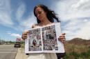 Wasatch High School sophomore Kimberly Montoya, 16, points to her altered school yearbook photo, upper left, Thursday, May 29, 2014, in Heber City, in Utah. A group of Utah high school students, including Montoya, said they were shocked and upset to discover their school yearbook photos were digitally altered, with sleeves and higher necklines drawn on to cover up bare skin. (AP Photo/Rick Bowmer)