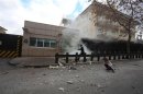 A security officer runs after an explosion at the entrance of the U.S. embassy in Ankara