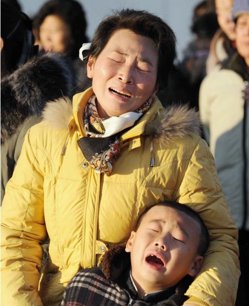 A woman and her son cry as they mourn the death of North Korean leader Kim Jong-il at a square on Mansu Hill in Pyongyang
