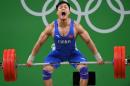 China's Lyu Xiaojun competes during the Men's 77kg weightlifting competition at the Rio 2016 Olympic Games in Rio de Janeiro on August 10, 2016