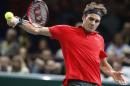 Roger Federer of Switzerland returns the ball to Jeremy Chardy of France during their second round match at the ATP World Tour Masters tennis tournament at Bercy stadium in Paris, France, Wednesday, Oct. 29, 2014. 2(AP Photo/Michel Euler)