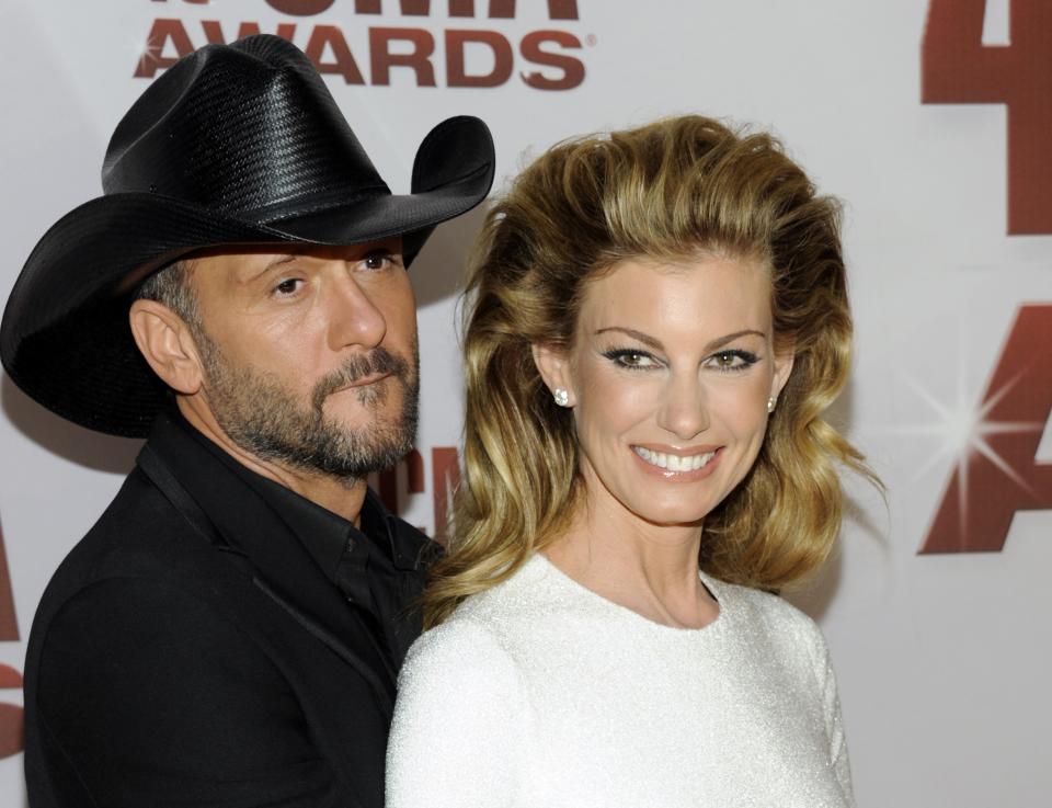 FILE - This Nov. 9, 2011 file photo shows country singers Tim McGraw, left, and his wife Faith Hill at the 45th Annual CMA Awards in Nashville, Tenn. McGraw and Hill are brushing off divorce rumors as they power into a new round of “Soul2Soul” duet performances in Las Vegas. The country music royals sat close and joked with each other about tabloid headlines during a round table interview with reporters before their Friday Nov. 15, 2013, show at the Venetian casino. (AP Photo/Evan Agostini, file)