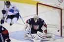 The puck goes wide of the net as Finland forward Leo Komarov (71) jumps and U.S. goalie Jonathan Quick (32) watches during the third period of an exhibition hockey game, part of the World Cup of Hockey, Tuesday, Sept. 13, 2016, in Washington. The United States won 3-2. (AP Photo/Nick Wass)