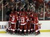 Detroit Red Wings players celebrate Henrik Zetterberg's goal in overtime against the Anaheim Ducks in Game 6 of a first-round NHL hockey Stanley Cup playoff series in Detroit, Friday, May 10, 2013. Detroit won 4-3. (AP Photo/Paul Sancya)