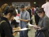 Job seekers fill out applications during 11th annual Skid Row Career Fair the Los Angeles Mission in Los Angeles