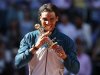 Nadal of Spain bites the Ion Tiriac's trophy as he poses after winning the Madrid Open final tennis match against Wawrinka of Switzerland in Madrid