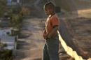 A Mexican boy stands near the wall which separates Mexico from the United States on January 24, 2006, in Tijuana, state of Baja California