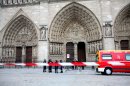 Police officers stand guard in front of Notre Dame Cathedral, in Paris, Tuesday, May 21, 2013. Notre Dame has been evacuated after a man committed suicide in the 850-year-old monument and tourist attraction. (AP Photo/Thibault Camus)