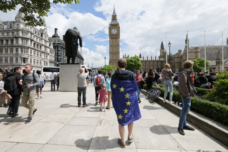 A demonstrator wrapped in the EU flag takes part in a protest opposing Britain's exit from the European Union in Parliament Square following yesterday...