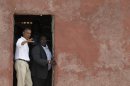 U.S. President Barack Obama, left, talks with Slave House curator Eloi Coly, as they look out to sea through the 'Door of No Return,' on Goree Island, in Dakar, Senegal, Thursday, June 27, 2013. Obama is calling his visit to a Senegalese island from which Africans were said to have been shipped across the Atlantic Ocean into slavery, a 'very powerful moment.' President Obama was in Dakar Thursday as part of a weeklong trip to Africa, a three-country visit aimed at overcoming disappointment on the continent over the first black U.S. president's lack of personal engagement during his first term.(AP Photo/Rebecca Blackwell)
