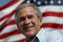 U.S. President George W. Bush smiles while speaking   at a campaign rally in Lakeland, Florida, October 23, 2004. REUTERS/Kevin   Lamarque/Files
