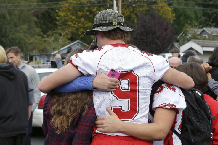 Students comfort each other following a shooting at Marysville-Pilchuck High School in Washington. (AP/Ted S. Warren)  CLICK for slideshow on Washington State school shooting.