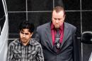 File - In this Jan. 8, 2016 file photo, Omar Faraj Saeed Al Hardan, left, is escorted by U.S. Marshals from the Bob Casey Federal Courthouse, in Houston. Al Hardan, who came to Houston from Iraq in 2009 is set to be arraigned Wednesday, Jan. 13, 2015, and have a bond hearing after his arrest on charges he tried to help the Islamic State group. (AP Photo/Bob Levey, File)