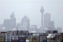 Container ship passes in front of the Sydney skyline as it departs from Port Botany terminal