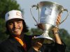 Rickie Fowler holds the trophy after winning the Wells Fargo Championship golf tournament at Quail Hollow Club in Charlotte, N.C., Sunday, May 6, 2012. (AP Photo/Gerry Broome)