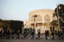 Riot police stand guard in front of the presidential palace in Cairo