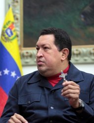Venezuala's President Hugo Chavez holds a crucifix in Caracas on December, 8, 2012, in this photo provided by the Presidencia. Chavez's son-in-law Jorge Arreaza, the country's minister of science and technology, said in a tweet that the cancer-stricken president's condition was "stable" but still delicate
