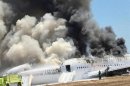 Asiana Airlines Boeing 777 is engulfed in smoke on the tarmac after a crash landing at San Francisco International Airport