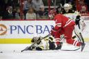 Boston Bruins' Zdeno Chara (33), of Slovakia, falls to the ice chasing the puck with Carolina Hurricanes' Eric Staal (12) during the first period of an NHL hockey game in Raleigh, N.C., Friday, Feb. 26, 2016. (AP Photo/Gerry Broome)